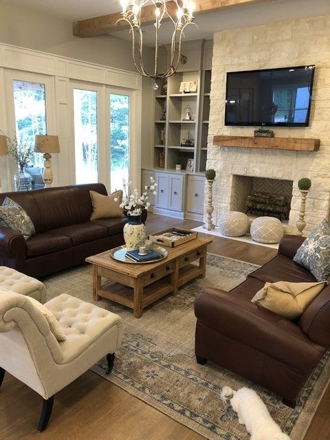 This is an example of symmetry because both sides of the room have identical furniture mirroring each other. Even the throw pillows and the decor in front of the fireplace…