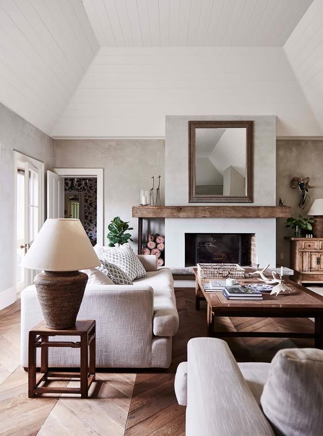 Living room with reclaimed timber floorboards, a fireplace with an oak mantle and sofas from Coco Republic | Photography: Lisa Cohen | Styling: Beck Simon