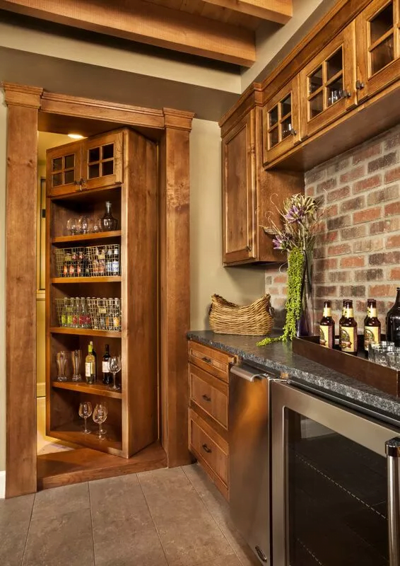 The built-in shelving swings open to reveal a hidden wine room.