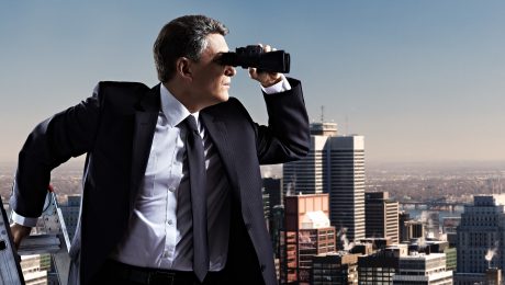Businessman with binoculars. Search concept. Property-Owners-View-Parametric-Insurance