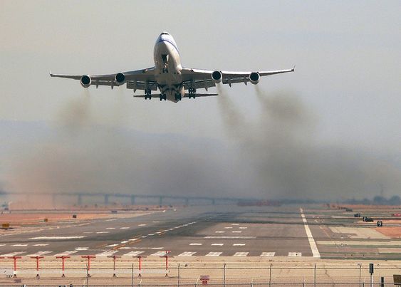 Airplane expelling pollution and fumes when taking off