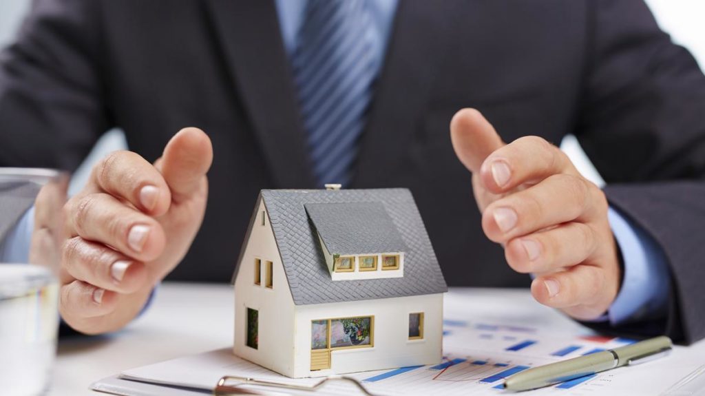 Man protecting a home with hands