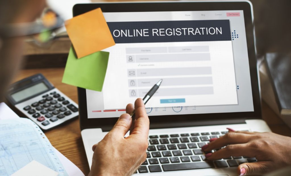 Two people going through the land registration process on their laptop